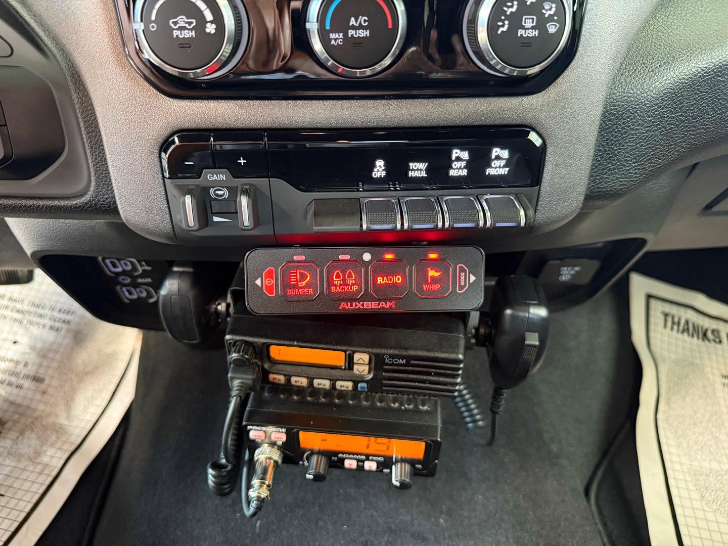 Dual CB and MURS radios installed with an auxiliary light controller in a pickup truck