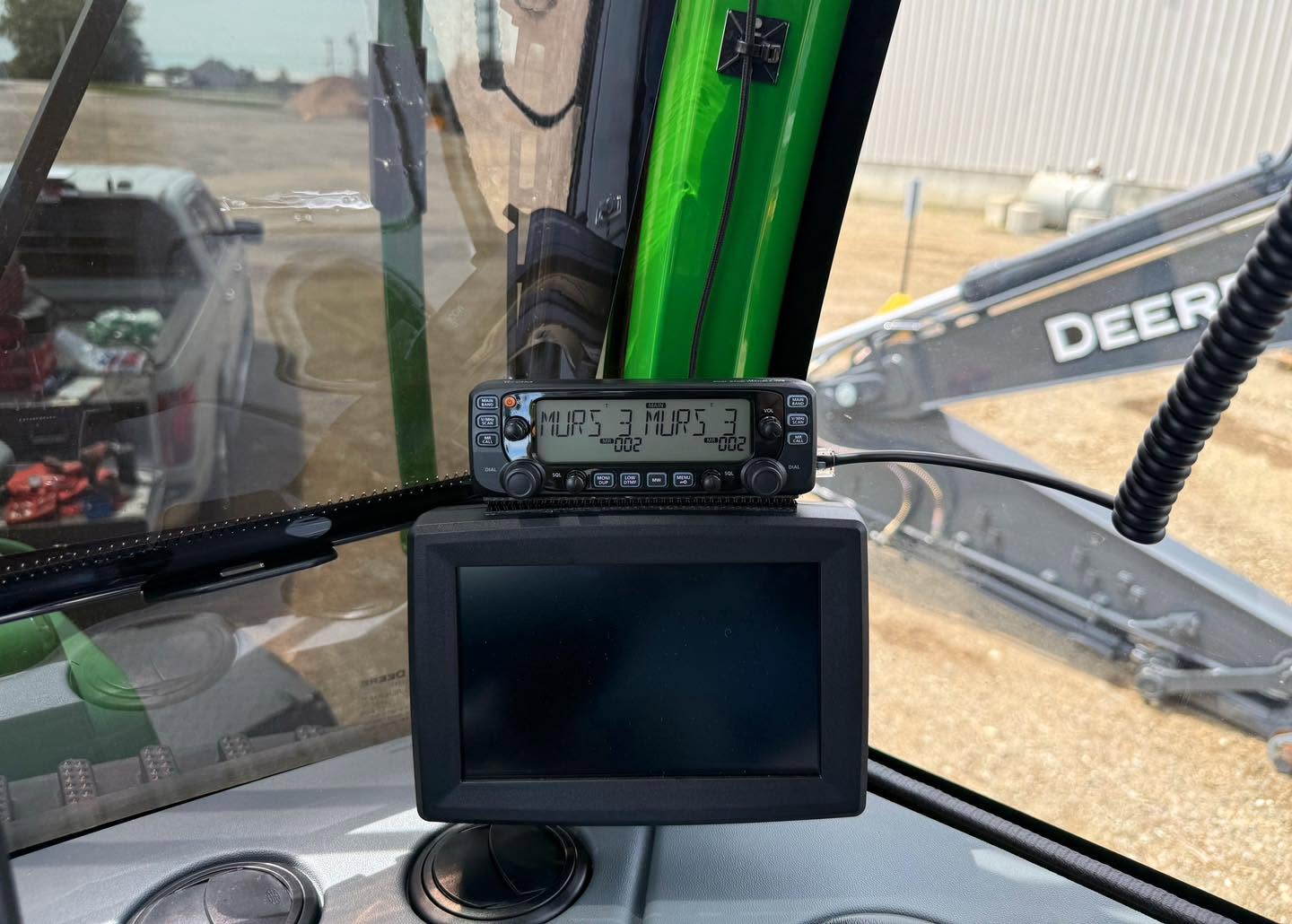 Two-way radio and display mounted in the cab of a John Deere forestry machine