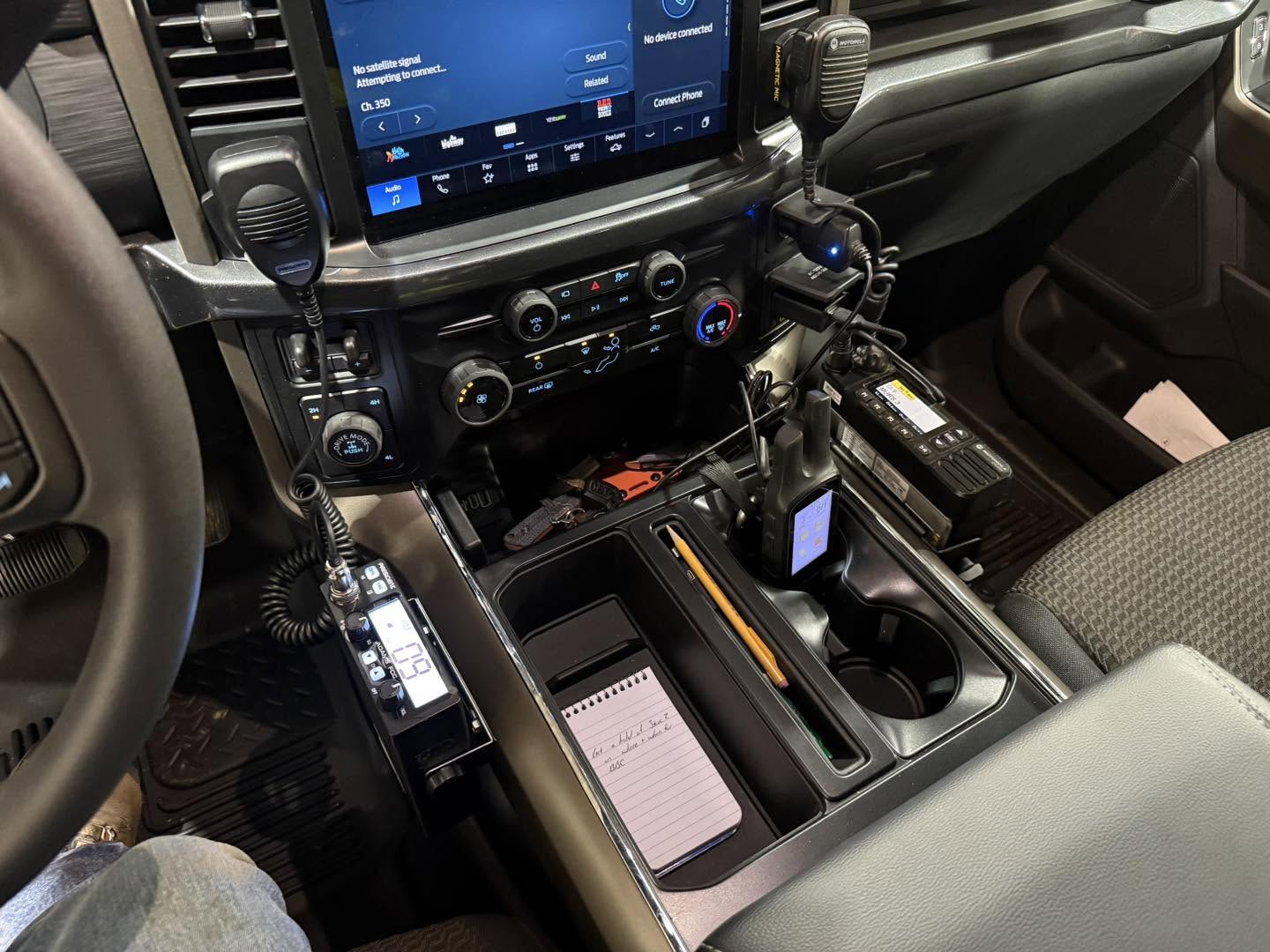 Dual two-way radio setup installed in a pickup truck center console