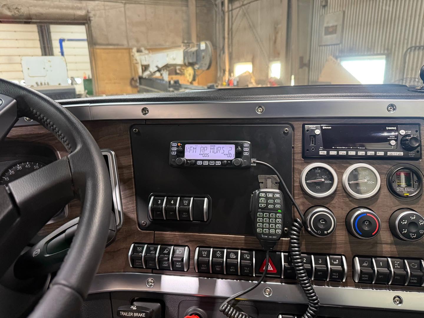 MURS radio and handheld microphone mounted on a semi-truck dashboard